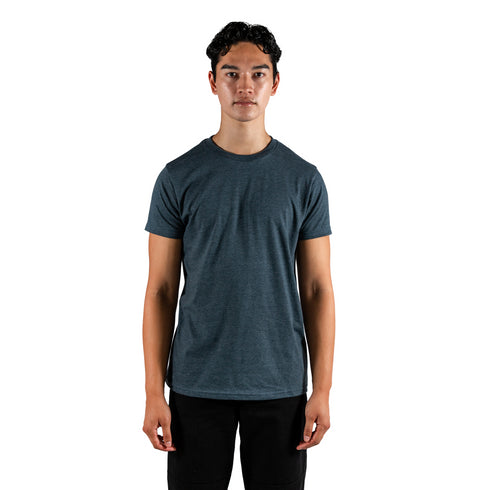 A man wearing a navy dual blend heather tee, showcasing a comfortable and stylish casual look.