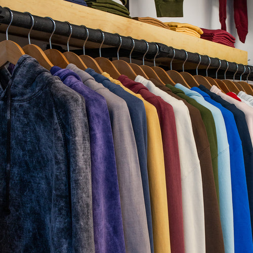 A collection of stylish apparel featuring the VISIT US logo, showcasing modern designs and vibrant colors for all occasions.